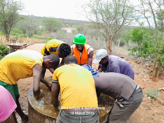 CIDES Training farmworkers on biogas feeding at Kitui South, Kitui County